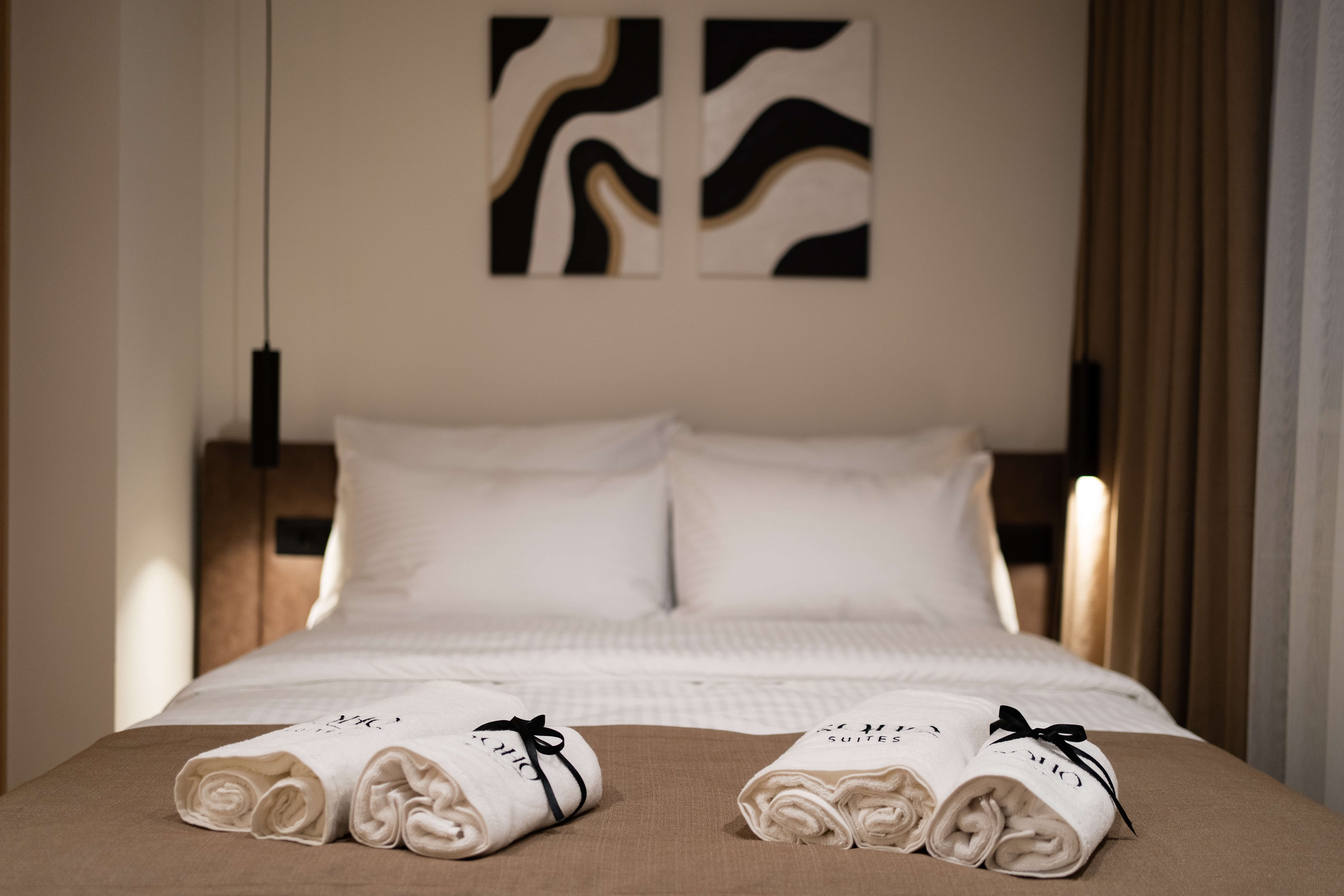 Soho Suites — calm beige bedroom with premium linen